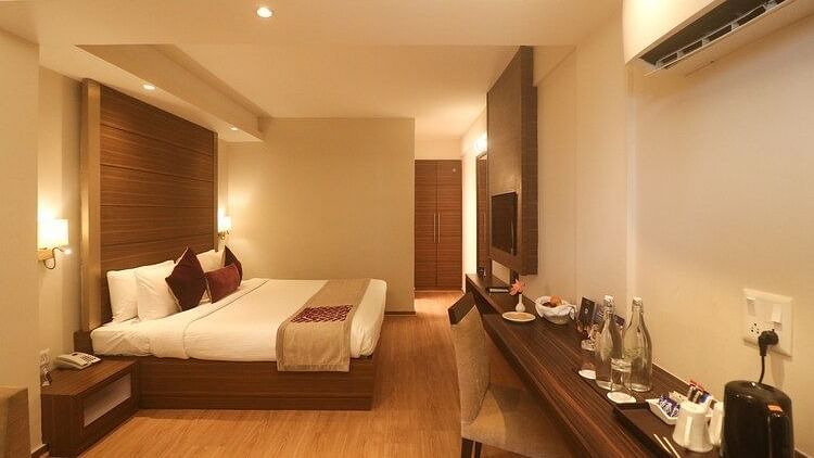A well-lit, spacious bedroom with a comfortable king-sized bed - Marigold Sarovar Portico, Mashobra-Shimla