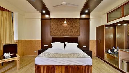 A well-lit room at DLS Hotel Devlok, Manali with a double bed
