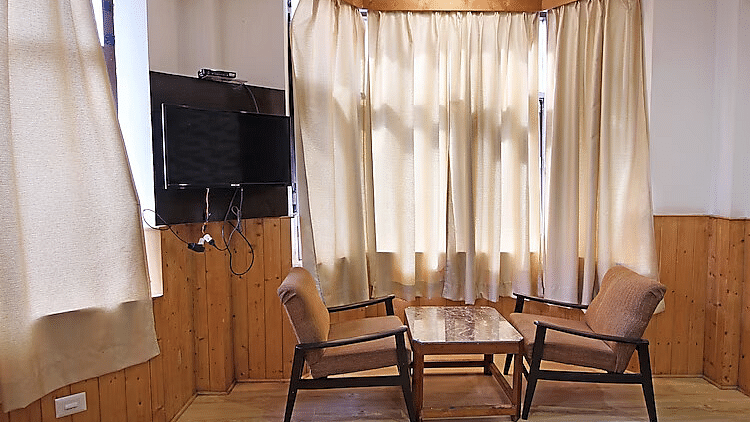 A room at DLS Hotel Devlok, Manali with a coffee table arrangement placed besides a window