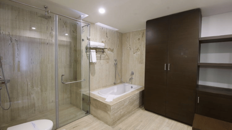 A contemporary hotel bathroom with a bathtub, shower area, and a large mirror - Ramada by Wyndham Bodh Gaya Mahabodhi