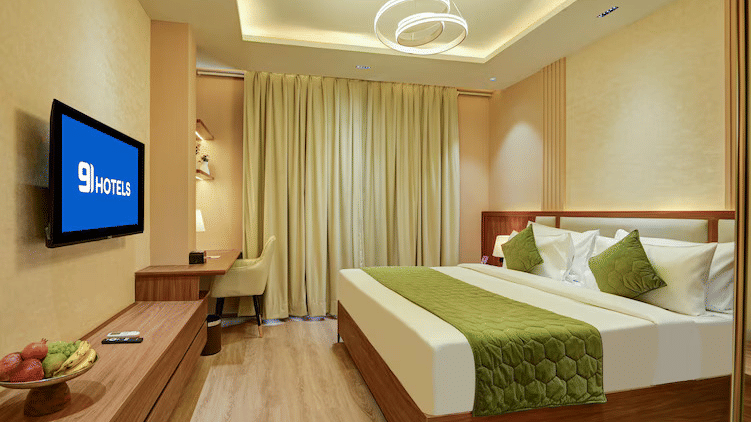 The Executive Room at Hotel 91 Privé, Gurugram, with bright interiors and modern amenities like a television.