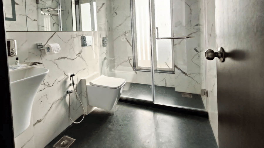 a spacious and clean bathroom at Maxxvalue Hotel, Chitranjan Tower, Powai with a separate shower space and wash basin