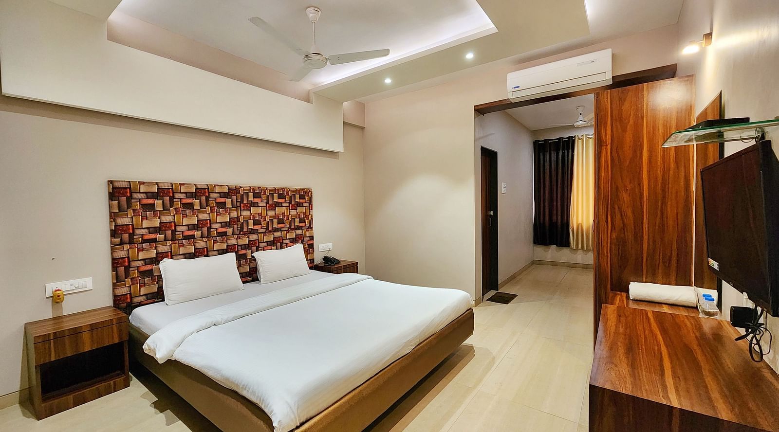 A Premium Room at The Kanila Resort featuring a bed, a desk, and a wardrobe.