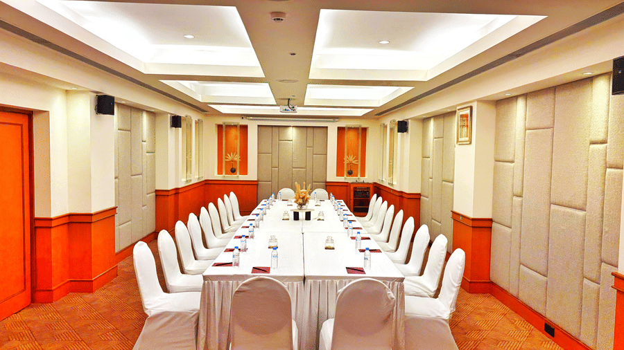 Banquet hall arranged in a U-shape seating setup with white chairs at The Residency Karur, suited for meetings and small conferences