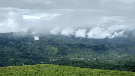 Monsoon clouds rolling across the lush forests and hills of Coorg.