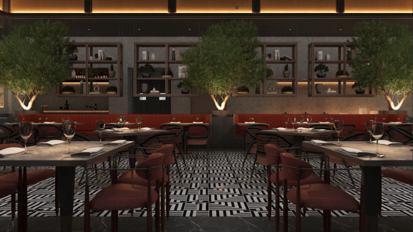 Restaurant dining room at Tulip Inn Bidar with dining tables, chairs, padded seating booths, potted plants, and a service bar in the background.