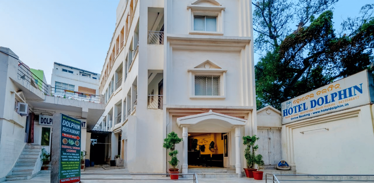 Front facade of Hotel Dolphin Puri with entrance signage and exterior architecture.