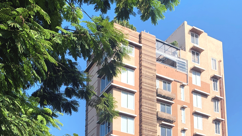 Facade of Theory9 Service Apartments in Bandra during the day with trees in view.