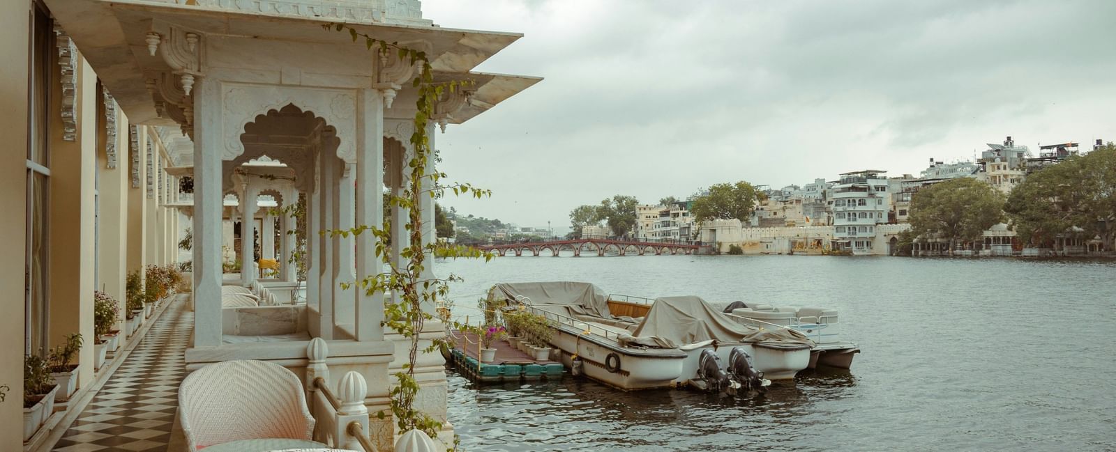 A view from the balcony of Bagore Ki Haveli near lake pichola with boats on the lake.