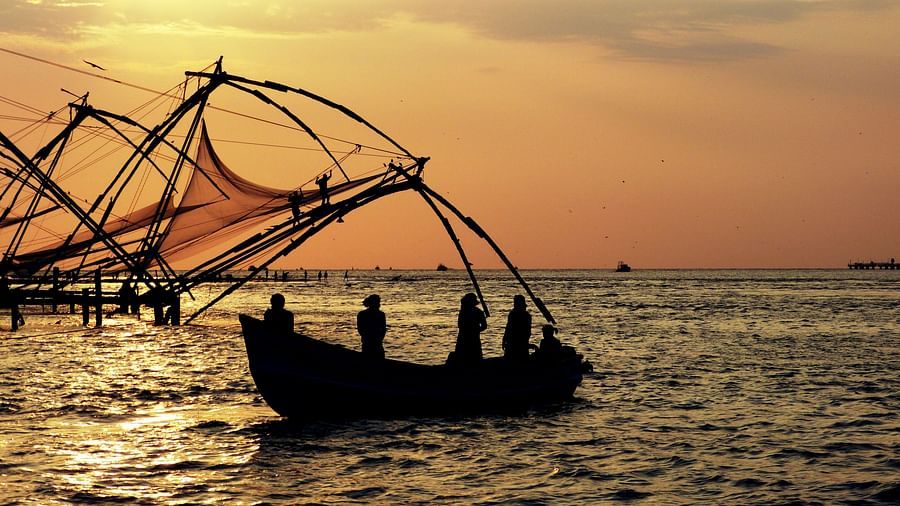 An overview of fishermen using Chinese nets from their boat to catch fishes.