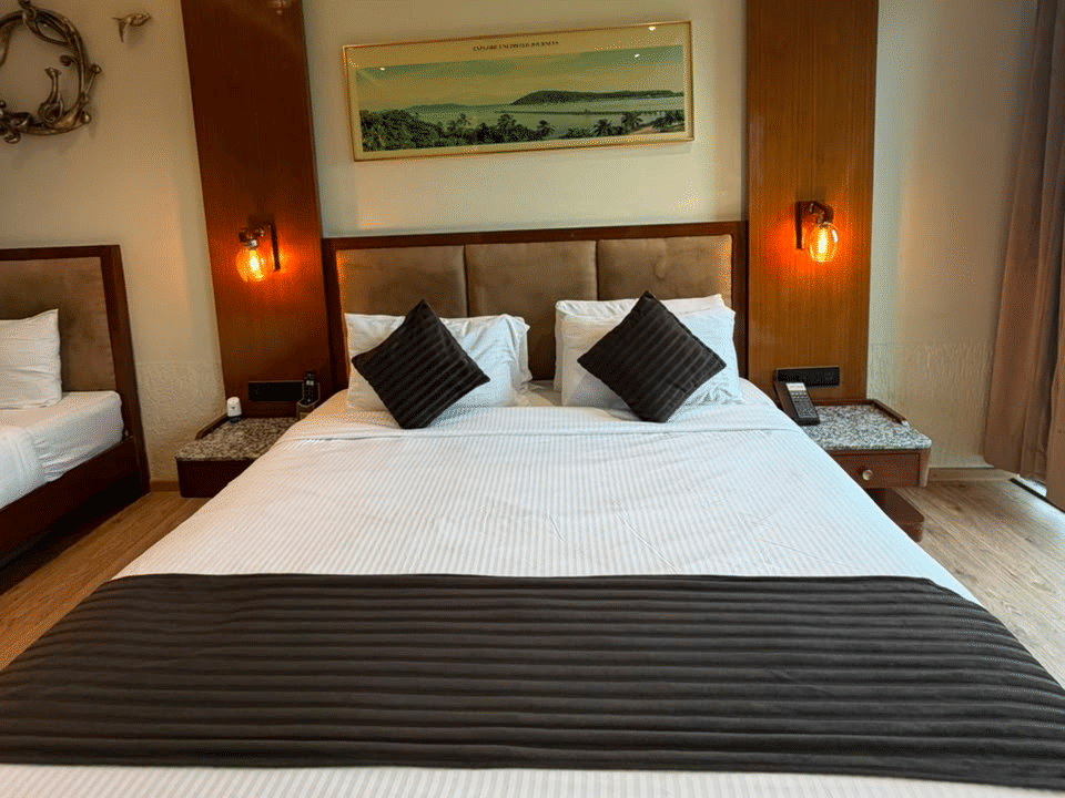 Skyline by Miraya, Family Room, Bed beneath the wall-mounted landscape