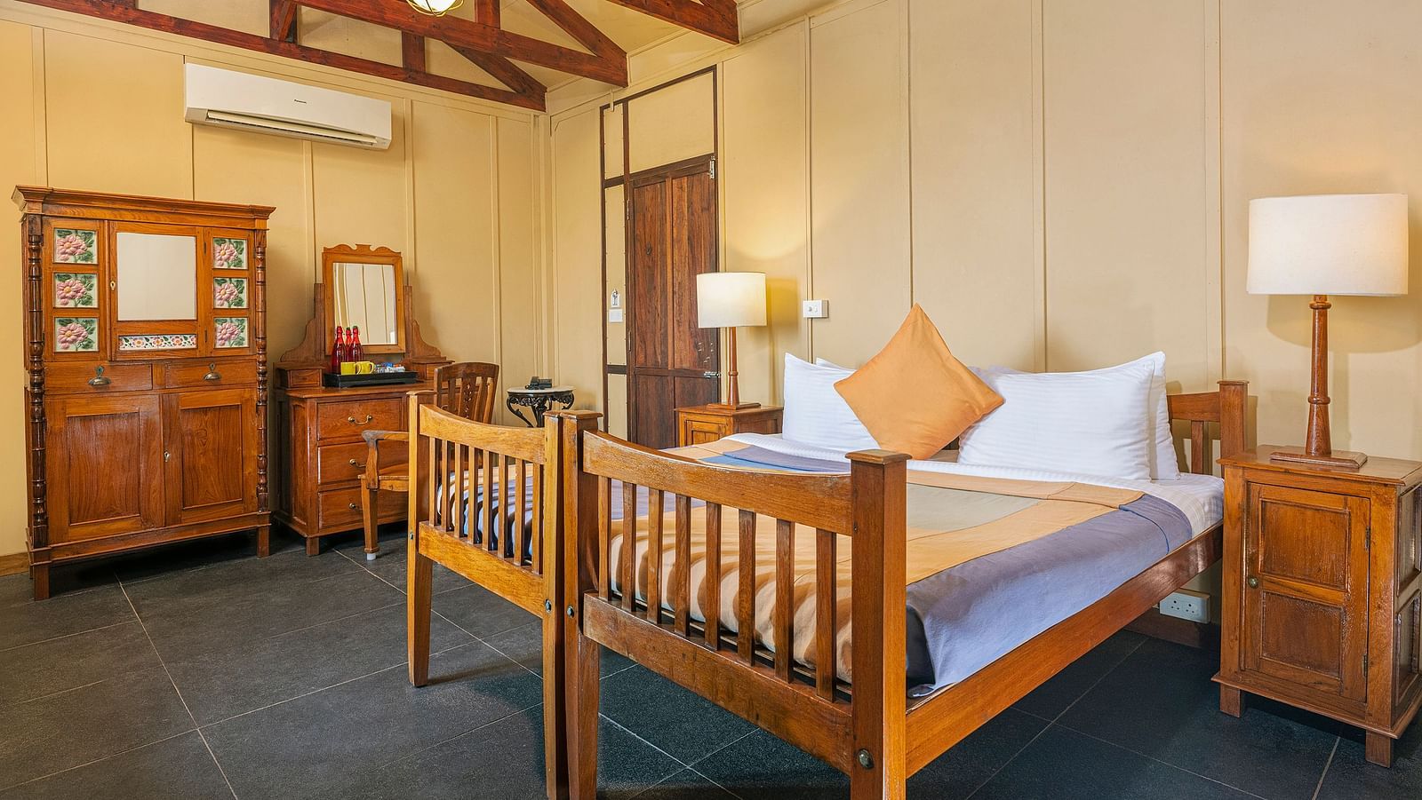 A double bed with side tables and lamps inside a Superior room | Mango Hill, Pondicherry