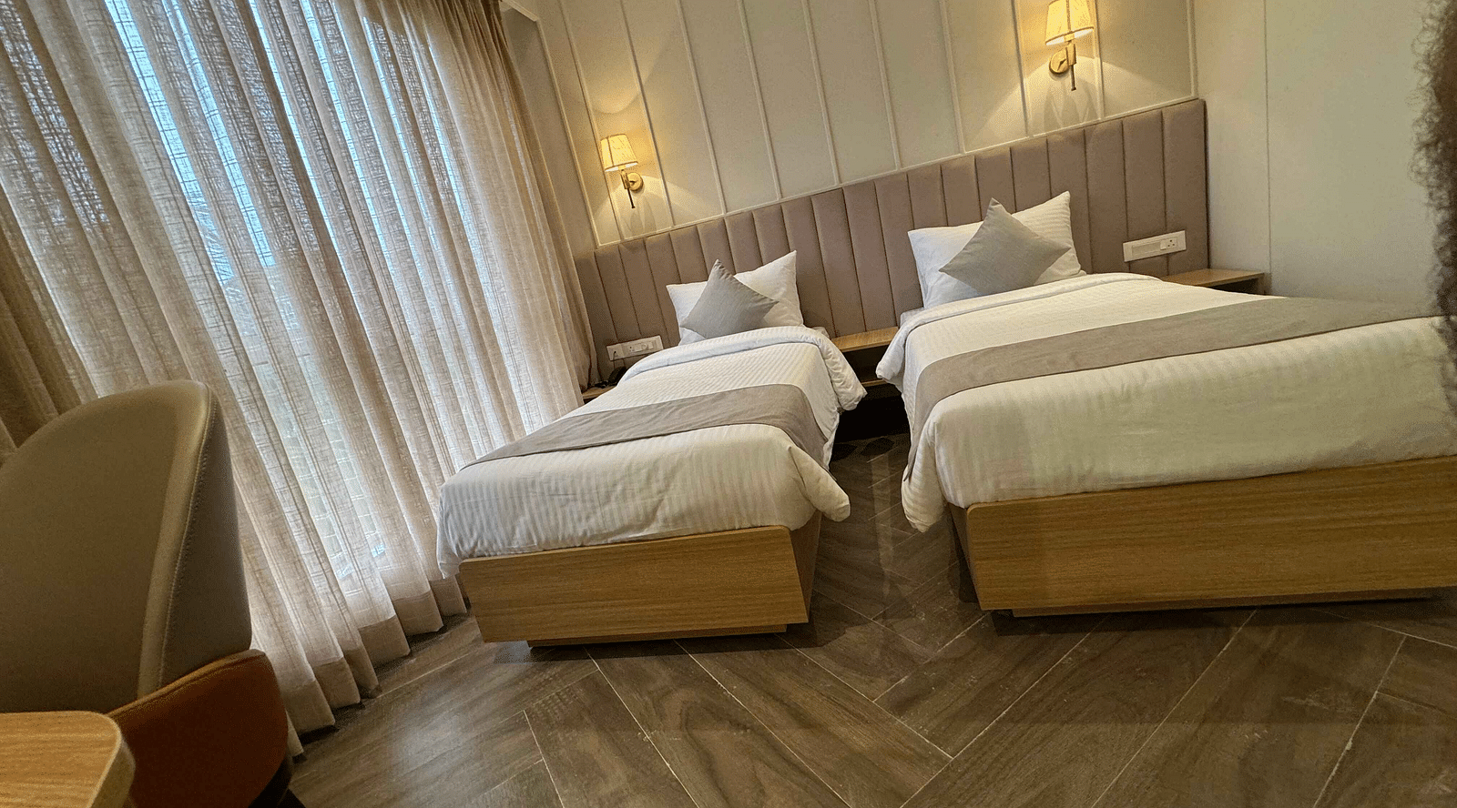 Image of twin bedroom with sheer curtain at  Hotel Mumbai House Mindspace Malad