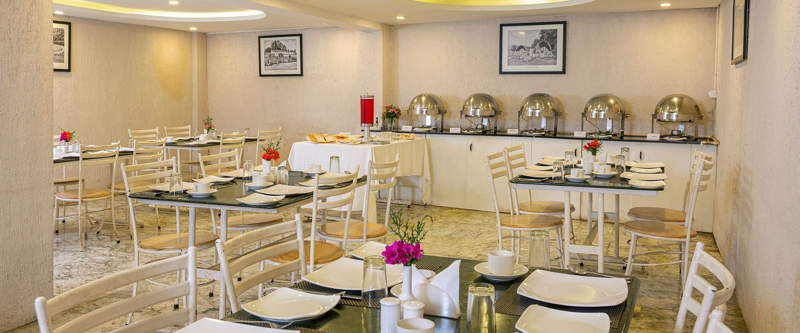 Elegant restaurant interior with buffet tables and decorative lighting | Mango HIll Central, Ooty