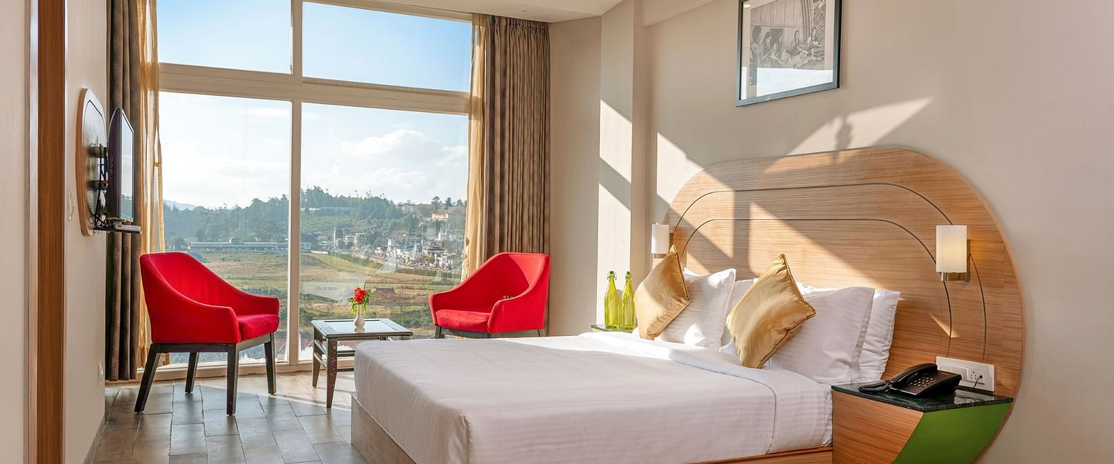 An image of a bedoom where natural light is seeping in through the glass window | Mango HIll Central, Ooty