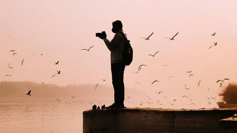 An image of a photographer clicking pictures of tourist places in Andaman and Nicobar islands specifically of birds