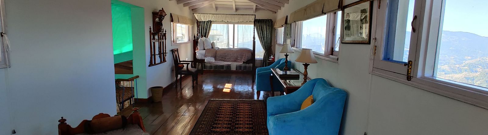Suite Room with open side window and wooden flooring at Te Aroha By Shervani, Mukteshwar