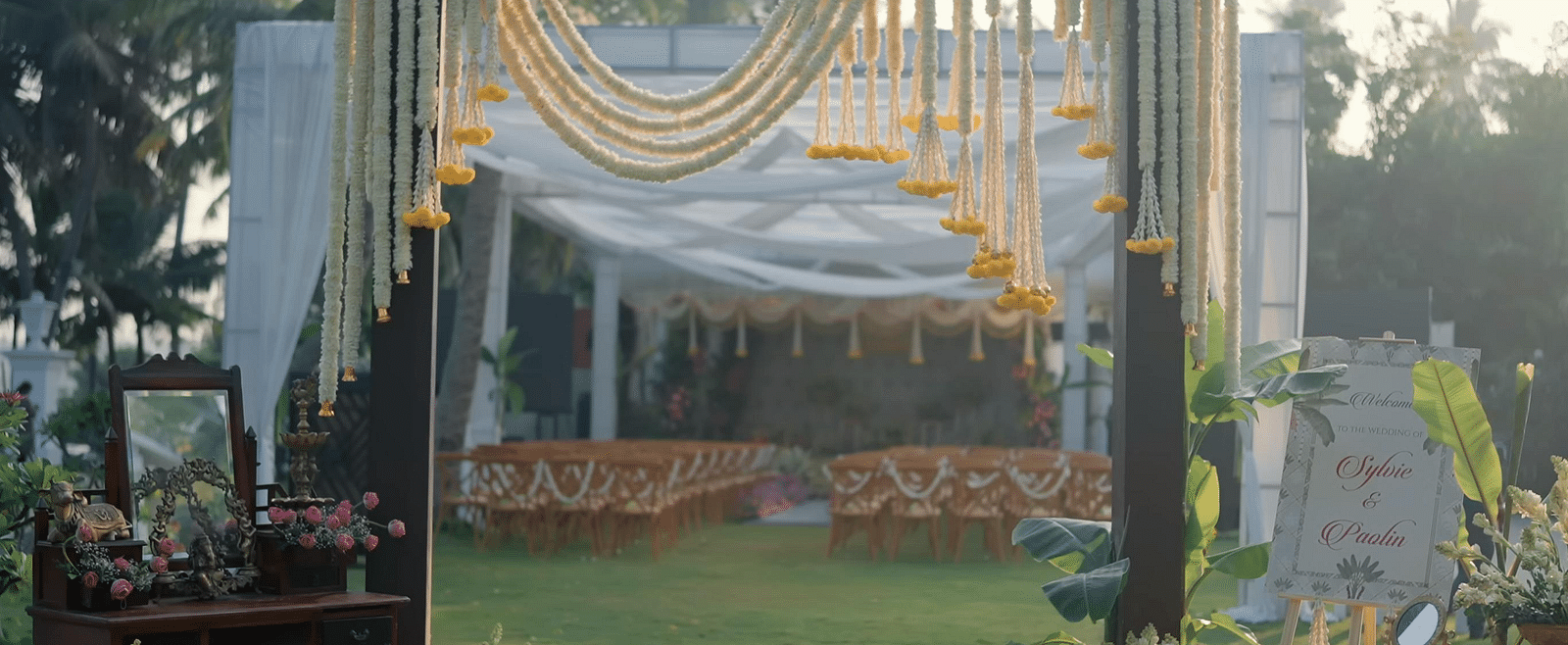 Outdoor wedding decor spread across a lawn.