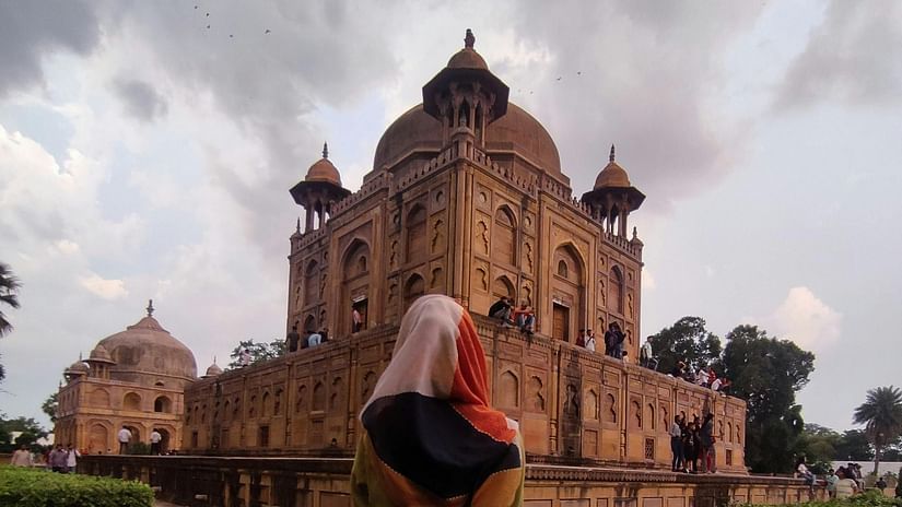 an image of a person walking towards a monument 