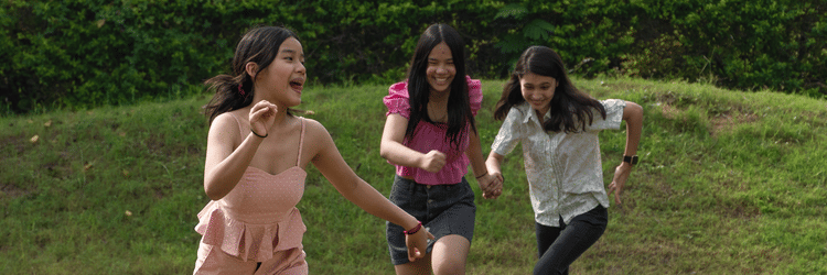 Three kids running on the lawns - Karma Lakelands.