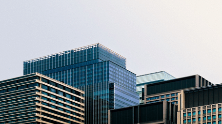 Contemporary office buildings and commercial complexes against a skyline.