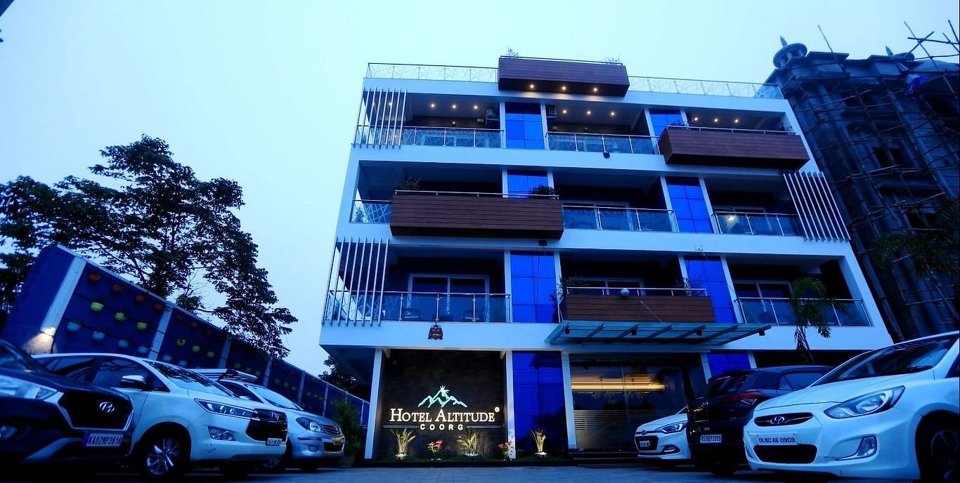 Facade of Hotel Altitude, Madikeri with carks parked in front of it at Hotel Altitude, Madikeri.