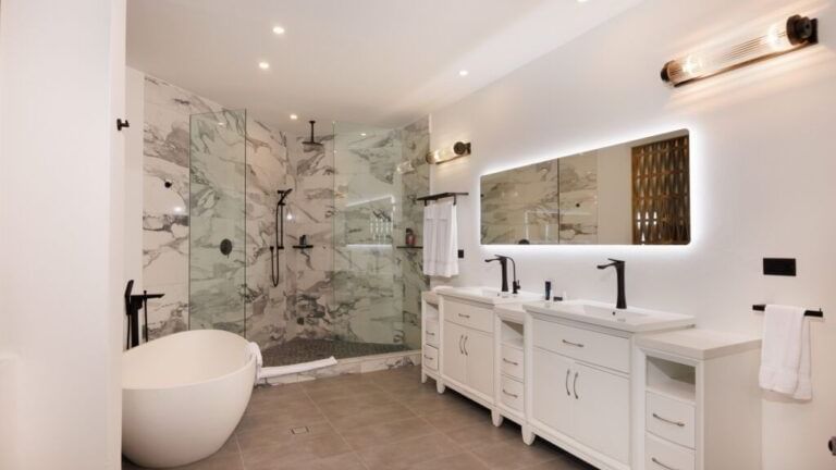 A luxurious bathroom with a free-standing bathtub, dual vanity, and marble-patterned walls