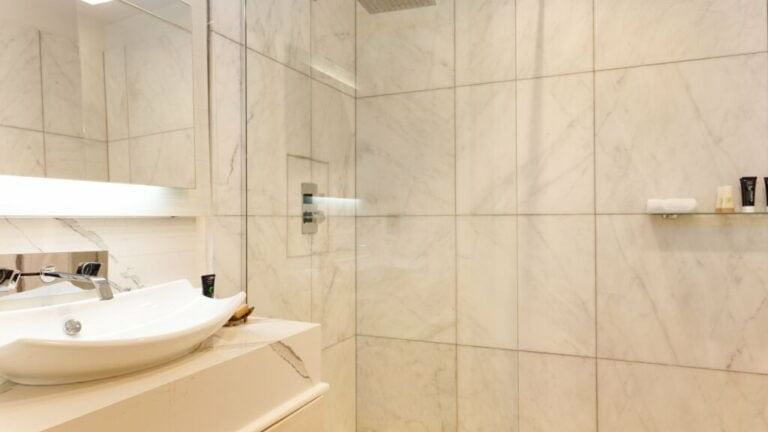 vanity area and shower of a bathroom in beachcomber at tamarind hills resort and villas antigua