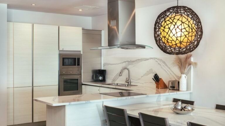 view of the minimally furnished kitchen and dining area of beachcomber at tamarind hills resort and villas antigua