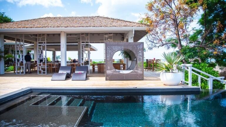A luxurious outdoor area features a swimming pool and a pavilion with seating.
