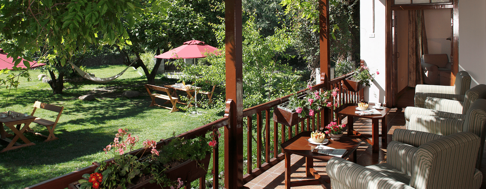 Deluxe room balcony offering a scenic view of lush greenery and a garden.