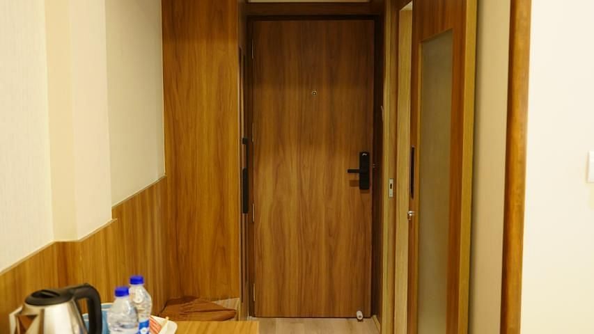 Spacious corridor view with a wooden wardrobe at Kalyan Residency Hotel, Tirupati – clean and functional design.