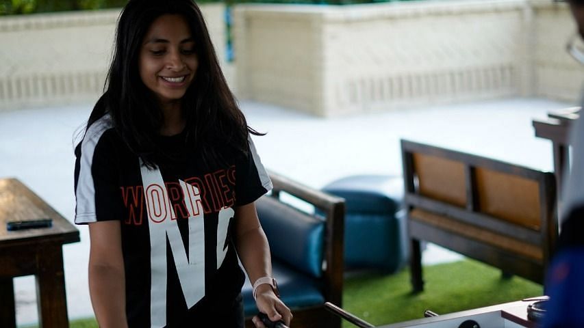 Woman enjoying foosball at inflated trampoline surrounded by trees at Themis Mudhouse - A Nature's Retreat Resort & Wellness