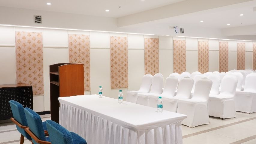 A bright meeting room with a long table and blue chairs, ideal for collaborative discussions at Shilton Dee Cee.