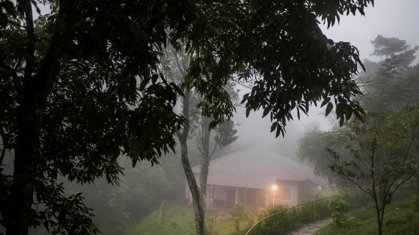 A misty evening view of a cottage with outdoor steps.- Abad Brookside Lakkidi, Wayanad
