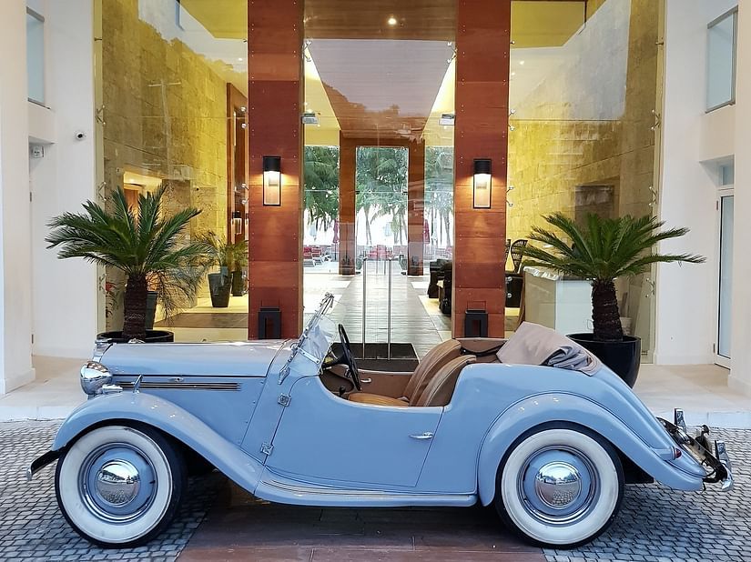 A vintage blue car placed in front of our hotel entrance - S Hotel Montego Bay, Jamaica