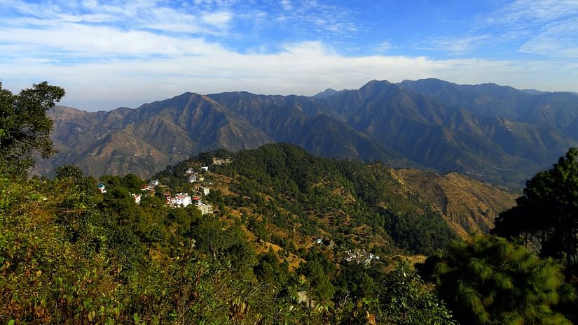 Green misty mountains under the sky