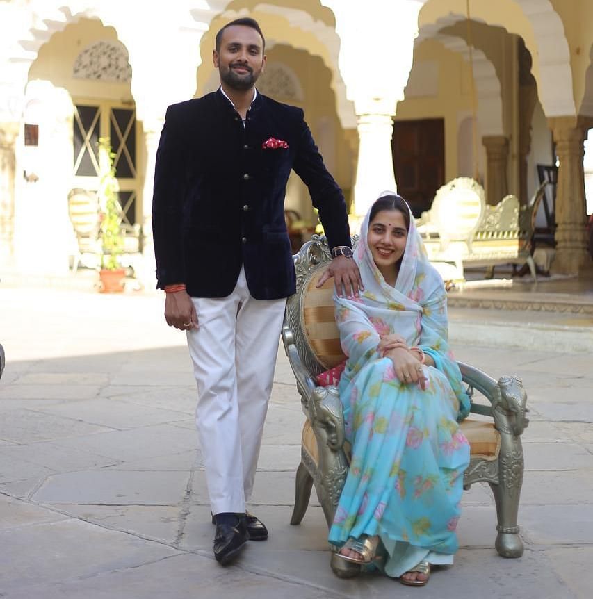 Mrs. Nityasri Rathore & Mr. Divyraj Singh Karansar standing in the open courtyard at Dileep Kothi, Jaipur during the day