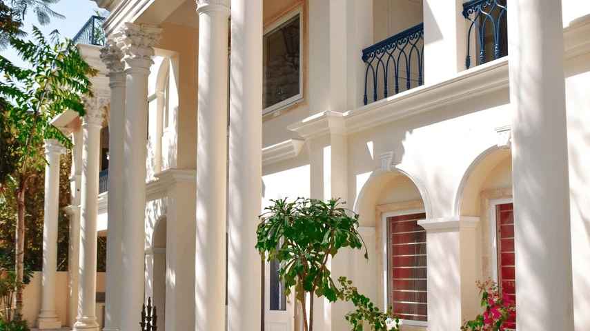 A portrait view of the exterior of a royal hotel in Jaipur with greenery surrounded - Dileep Kothi, Jaipur