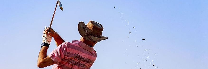A close up shot of a person playing golf.
