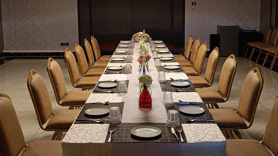 indoor event space with a huge table and chairs placed adjacent to each other at Hotel Eastern Gate, Port Blair