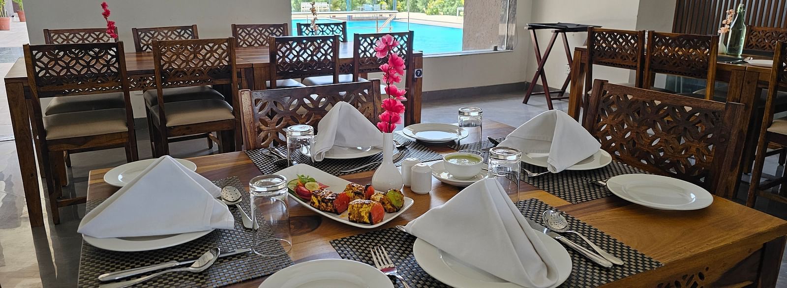 A dining table is laden with various food items and cutlery - Bamboo Saa Mulberry Resort, Pushkar