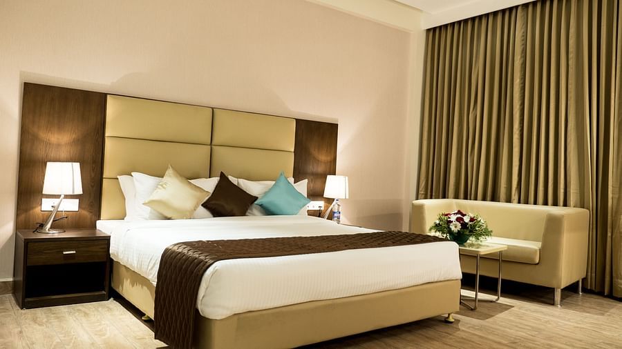 A large bed in Premium Room at Grand Ashok, Thanjavur.