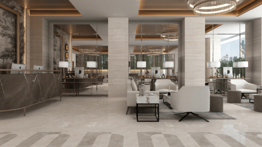 Spacious lobby area at Tulip Inn Bidar with marble flooring, modern seating areas, pillars, and glass partition walls.