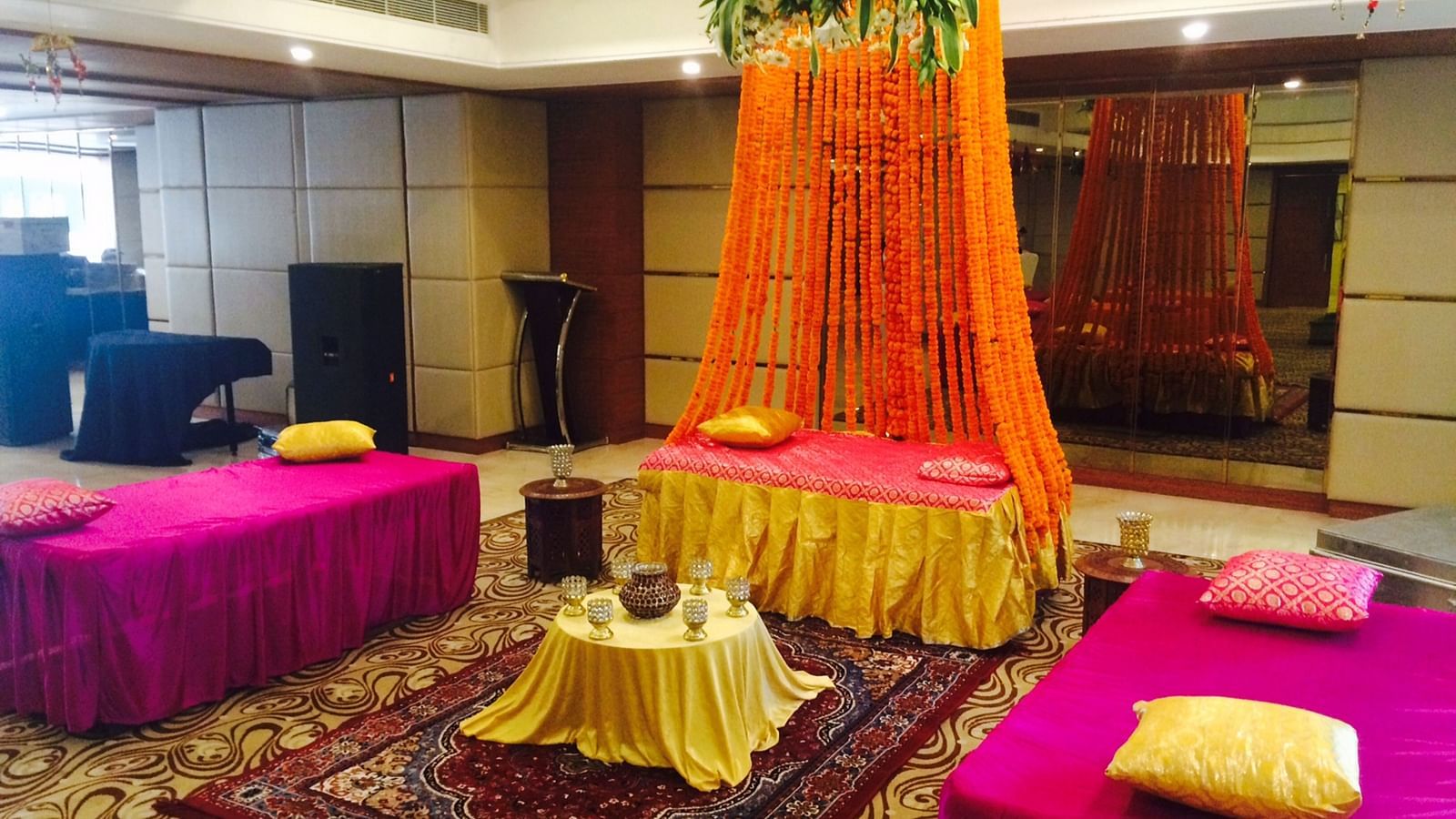 A beautiful seating area set up in the Emerald hall with a centre table kept over a patterned carpet - Ramada by Wyndham, Ghaziabad, Vasundhara