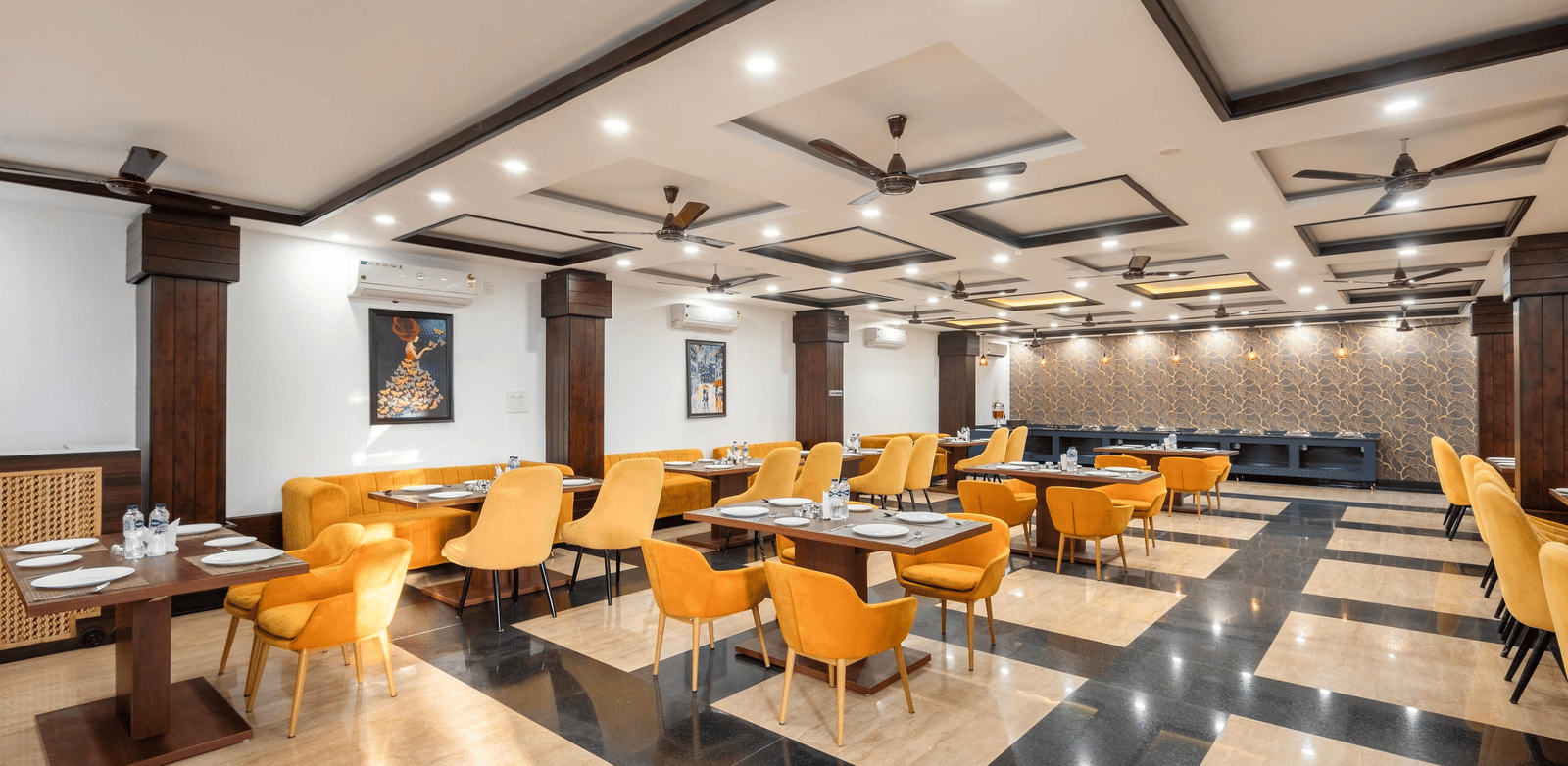 A dining hall with many tables and chairs and patterned floor tiles at Perfectstayz Premium Shanti Heritage, Haridwar