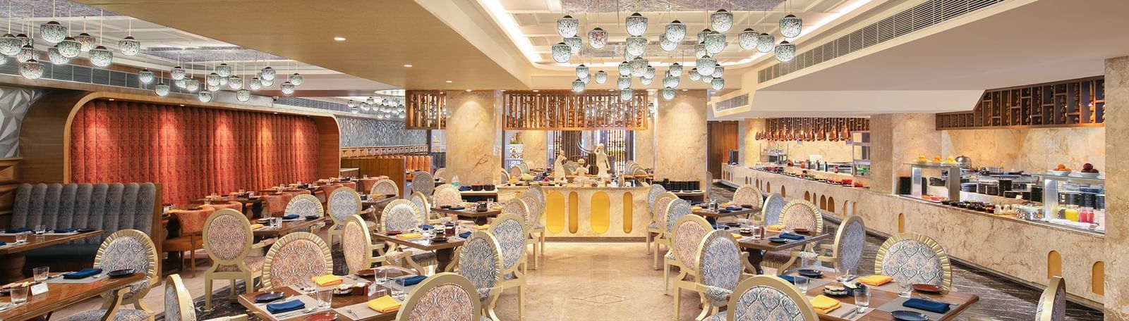 A spacious dining hall featuring modern decor and warm lighting - Kaldan Samudhra Palace