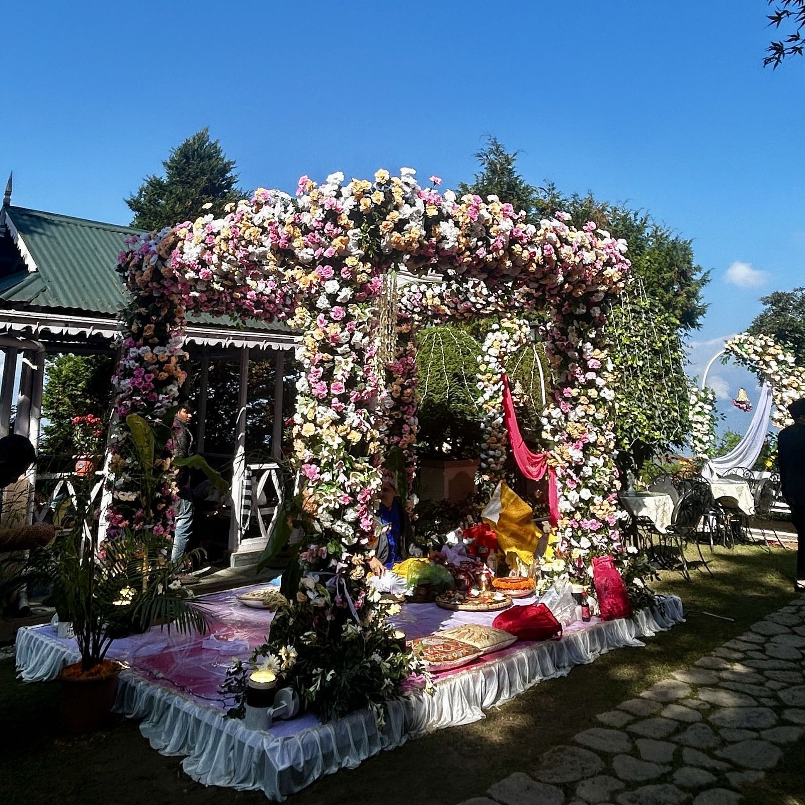 Outdoor wedding mandap at Cedar Inn, Darjeeling, placed on a garden platform with elegant floral detailing.