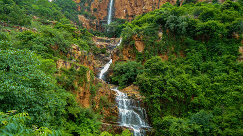 view of a waterfall encompassed by greenery