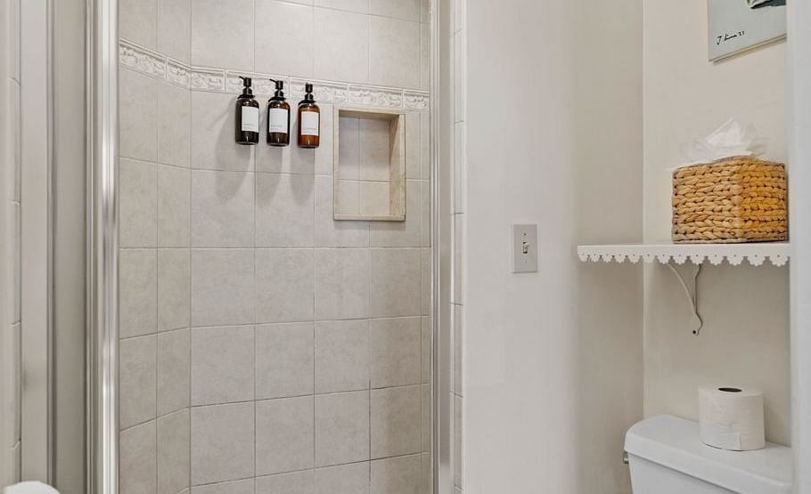 Compact bathroom with glass shower and toilet at Hartstone Inn